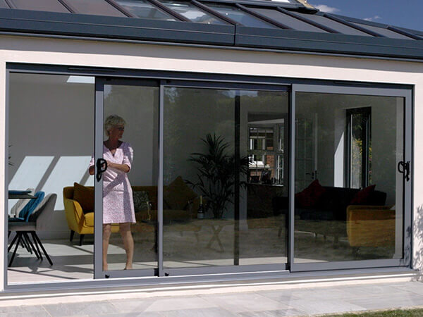 A lady operating her patio door